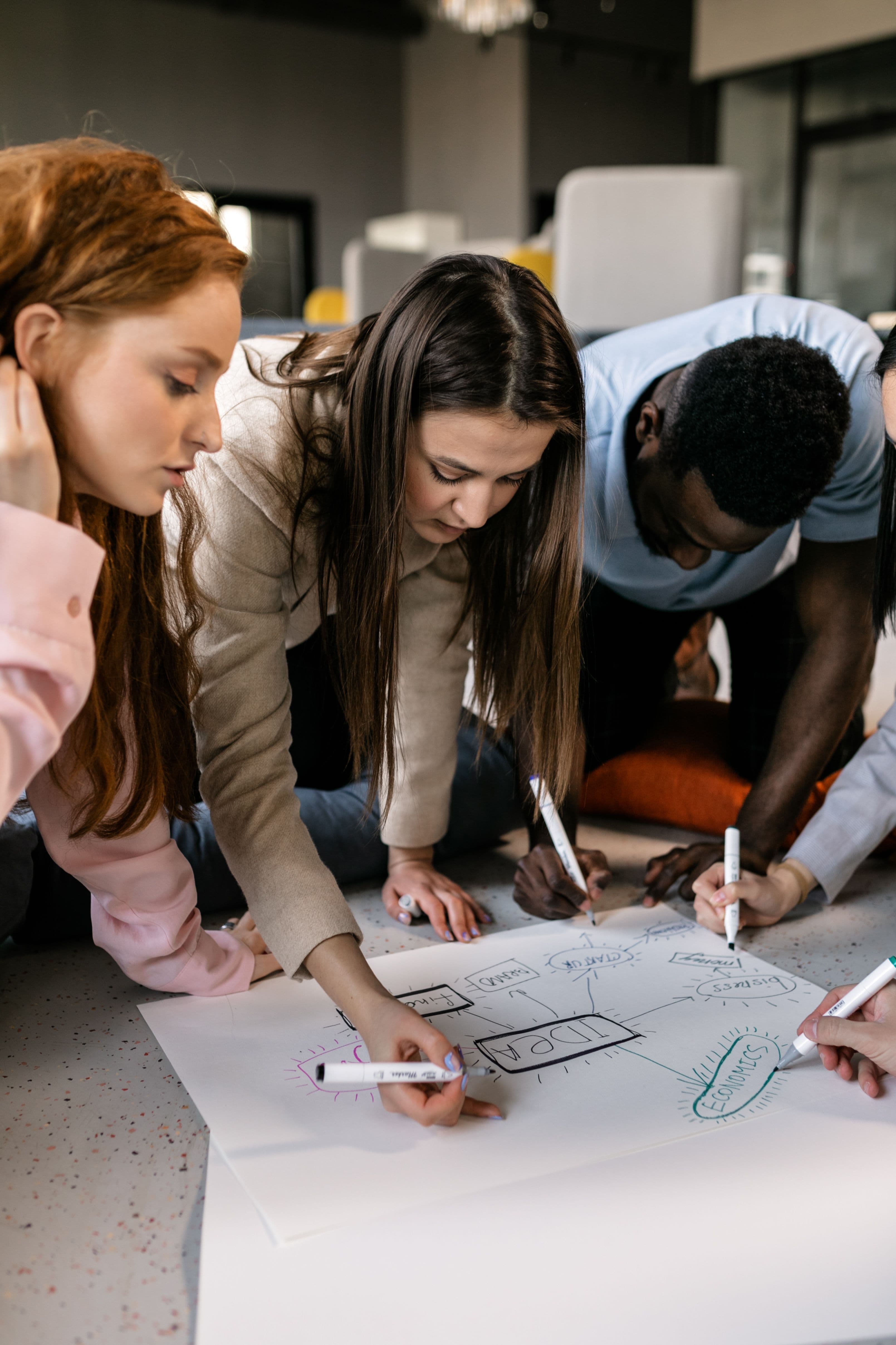 A team mapping out ideas together on paper
